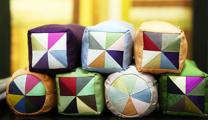 Pillows decorated in the traditional <i>jogakbo</i> patchwork pattern show the harmony of colors. 