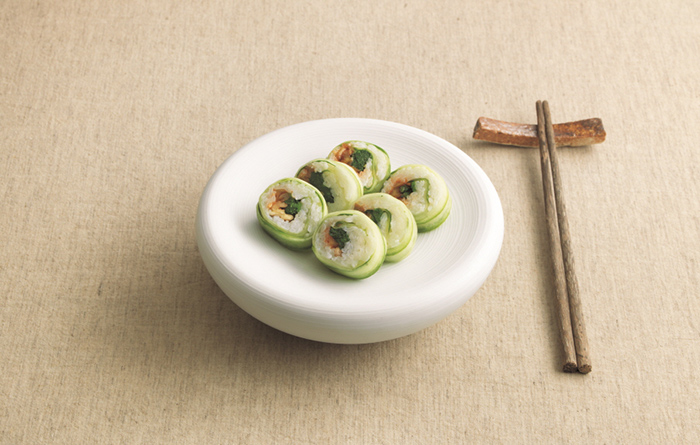 Cucumber-wrapped rice with seasonal herbs.