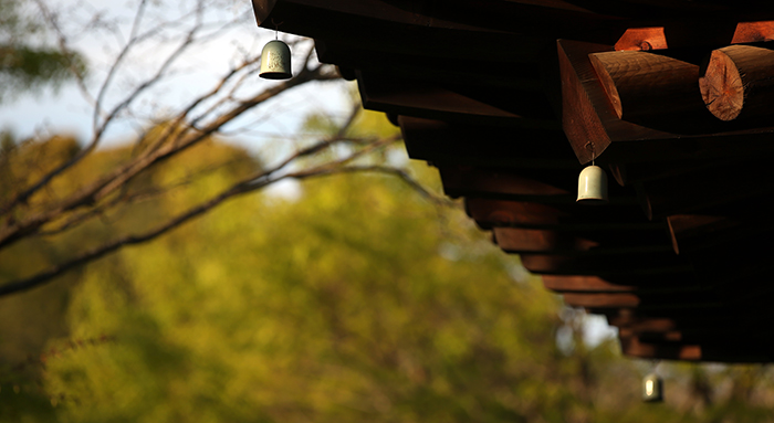 Celadon bells hang from the edge of the eaves of a pavilion on the grounds of the Gangjin Celadon Museum.