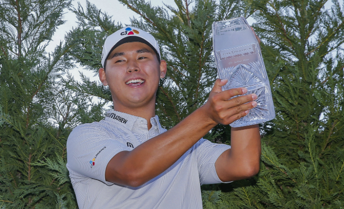Kim Si Woo smiles as he poses for a photo and holds up the trophy for the 2017 Players Championship, at TPC Sawgrass on May 14.