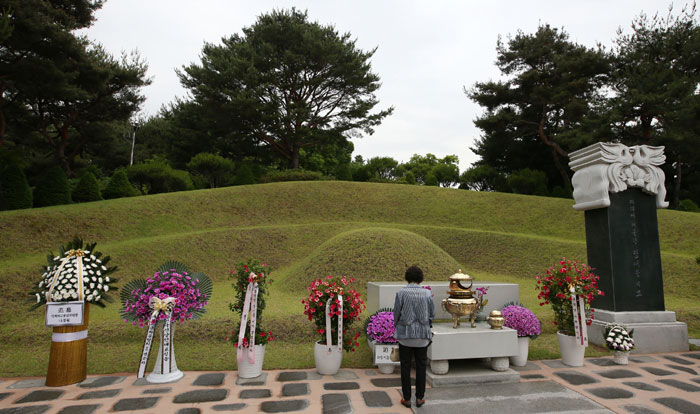 A visitor looks at the grave of former President Kim Dae-jung.