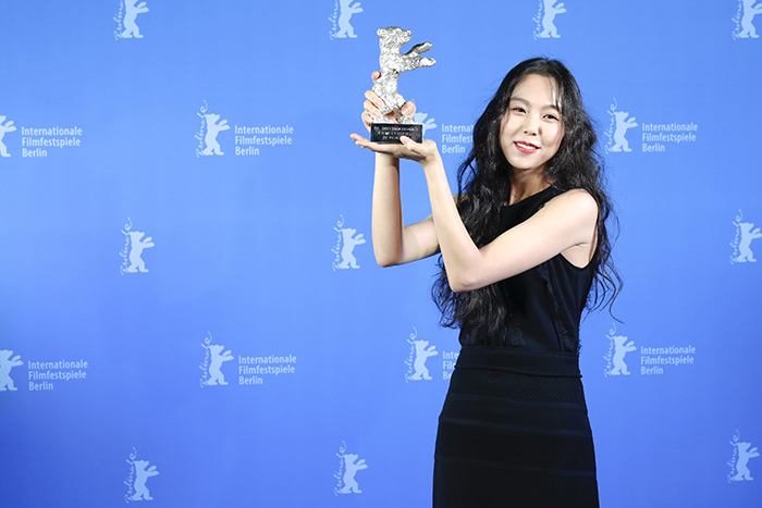 Kim Minhee poses for a photo after winning the Silver Bear for Best Actress award at the 67th Berlin International Film Festival.