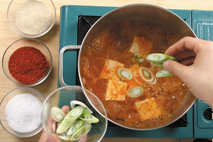 Add the broth and chili peppers to the pork and kimchi, and boil it all together for 30 minutes. You can add chill pepper or kimchi broth if you like.