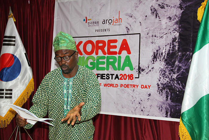 Clad in traditional Yoruba attire, Arojah Concepts CEO Jerry Adesewo reads ‘Song of Peace’ by Korean poet Ko Un.