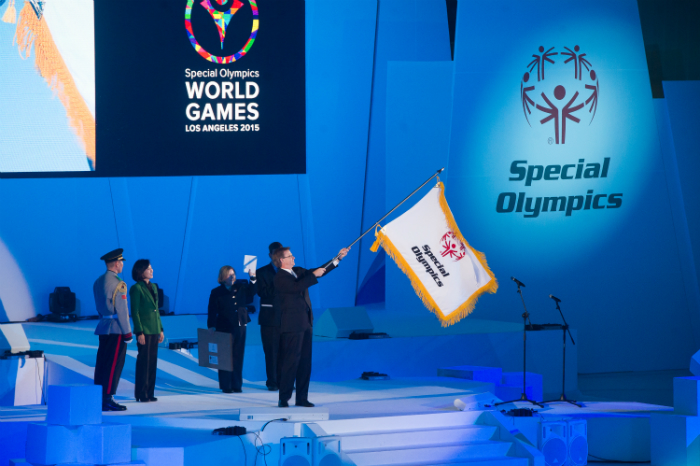 The Special Olympics flag is passed to the flag holder during the closing ceremony of the Games. Los Angeles is the venue for the next Special Olympics World Summer Games in 2015 (photo courtesy of the Special Olympics PyeongChang 2013 Organizing Committee).