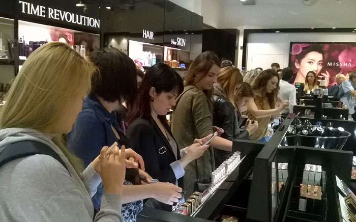 Korean cosmetics are one of the country's top exports thanks to soaring demand around the globe. The photo shows customers shopping at a newly-opened Missha outlet in Barcelona, Spain, last year.