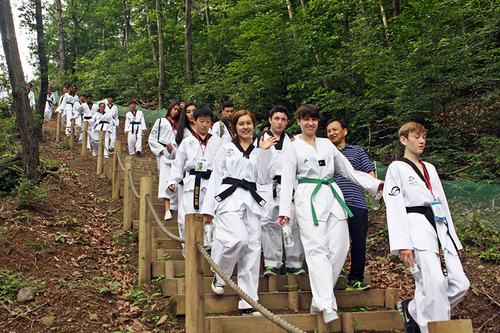 Taekwondo practitioners from around the world, clad in uniform, participate in a range of training programs on offer at the Taekwondowon in Muju, Joellabuk-do. 