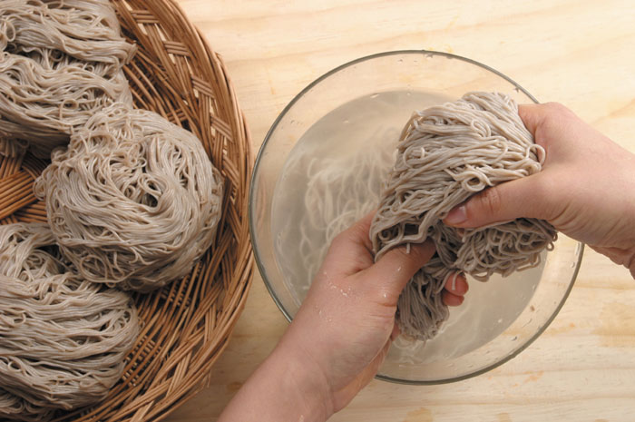Put the noodles in boiling water for two minutes. Strain the noodles and rub them under cold water. Make noodle coils and drain away any excess water.