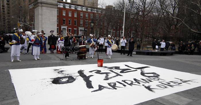 Calligrapher Lee Sang-hyun performs, writing the word “Arirang” with a large brush, in Times Square, Manhattan, in New York City on March 19. 