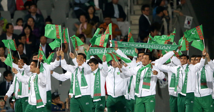Athletes from Indonesia (top) and Turkmenistan march into the stadium. 