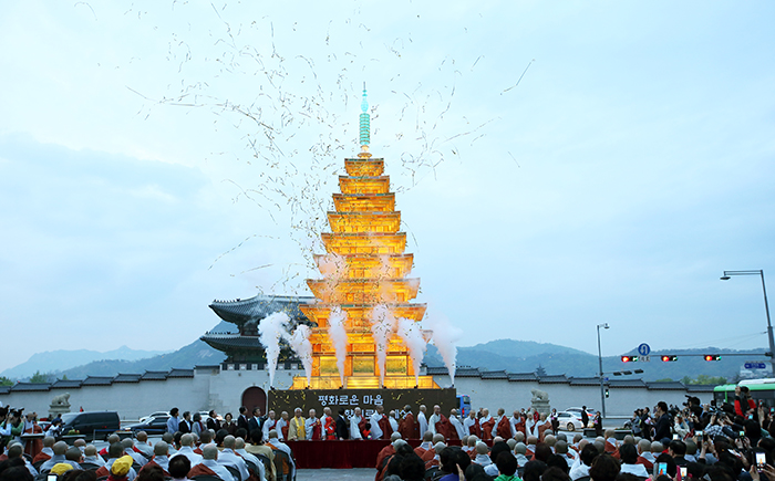 Buddhist monks, leaders from other religious groups and religious Buddhists light a lantern shaped like the pagoda at Mireuksa Temple, in Gwanghwamun Square on April 29.
