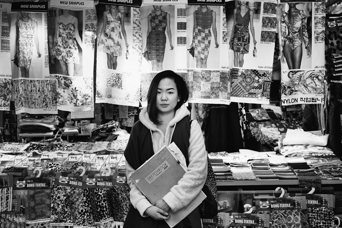 Rydia invites me to meet her at Dongdaemun Fabric Market. After meandering through the narrow aisles of the warehouse, we find her vendor’s booth. This is where she places special orders for her customized fabrics.