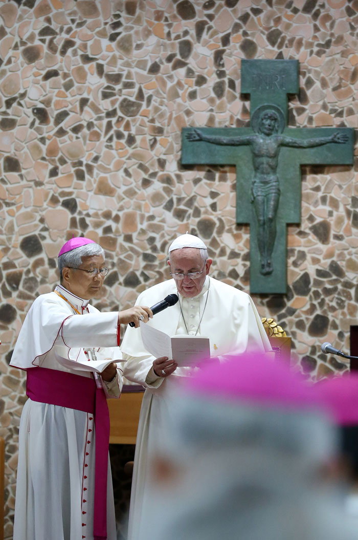 Pope Francis (right) reads a prayer during a meeting with Asian bishops.