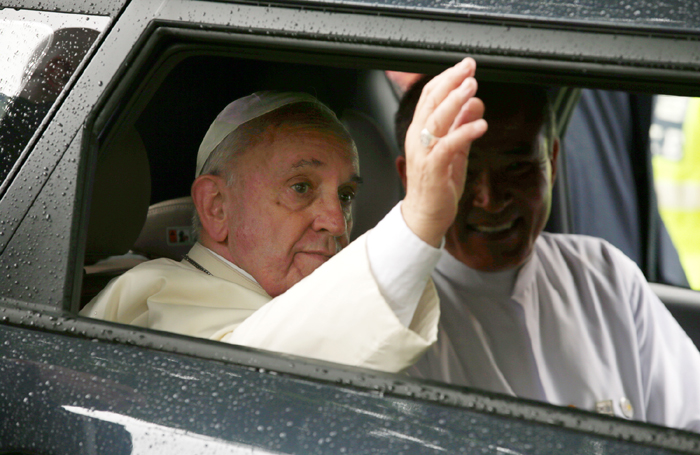 Pope Francis waves to the crowd from a Kia Soul as he heads for the Myeongdong Cathedral to celebrate a Mass for peace and reconciliation on August 18. 