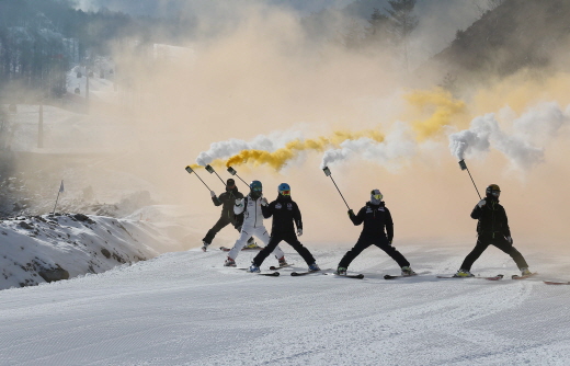 During the opening ceremony for the 2018 PyeongChang Winter Olympics Jeongseon Alpine Centre, athletes ski down the slope putting up a smokescreen on Jan. 22. 