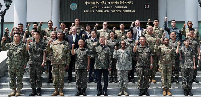 President Moon (front, center) shouts, 'We go together!' with soldiers and civilians at the Republic of Korea-U.S. Combined Forces Command in Seoul on June 13.