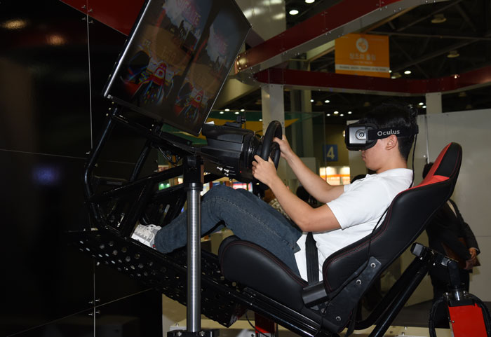 A visitor races a car in virtual reality.