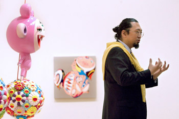 Japanese artist Takashi Murakami stands next to his sculpture of the character Kiki during his retrospective exhibition held at the Guggenheim Museum of Bilbao, Spain, in February 2009 (photo: Yonhap News).