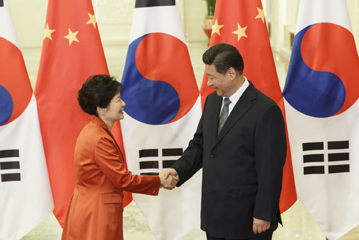 President Park Geun-hye (left) and Chinese President Xi Jinping shake hands prior to summit talks on November 10 in Beijing, China.