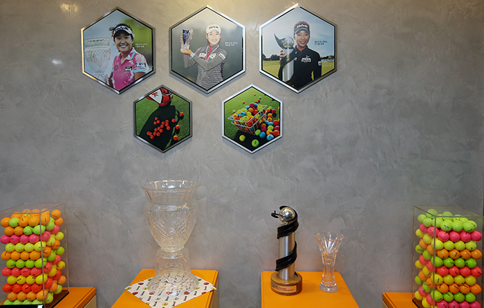 Photos of LPGA winners who won their competitions using Volvik colored golf balls, and their trophies, are on display at Volvik headquarters in Seoul.