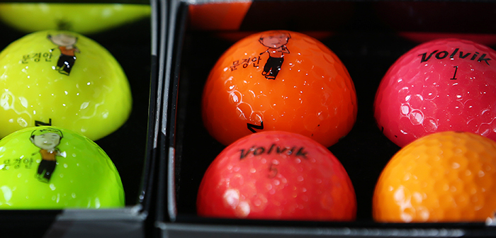 Colored golf balls with caricatures of famous golfers can be found in the offices of Volvik President Moon Kyung-ahn.
