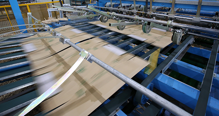 Automated production lines produce completed boxes non-stop.