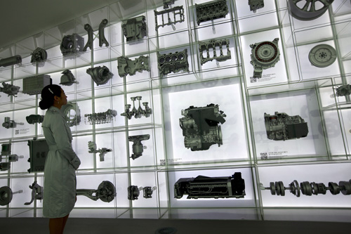 An exhibit at the Hyundai Motor Pavilion showcases models of Hyundai vehicles and vehicle parts that have been produced over the years 
