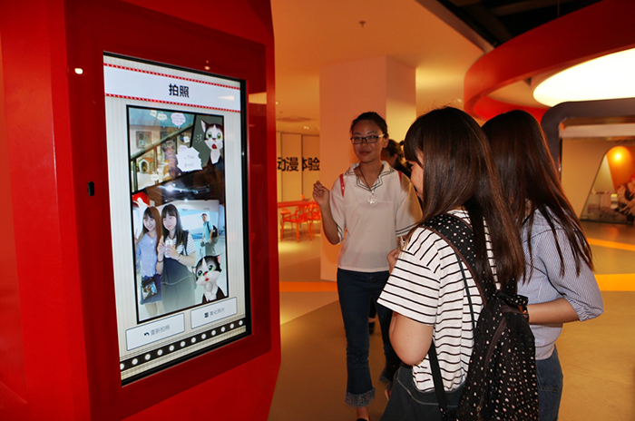 Visitors use a large-screen display unit at the China-Korea Cartoon Experience Center to read a comic strip.
