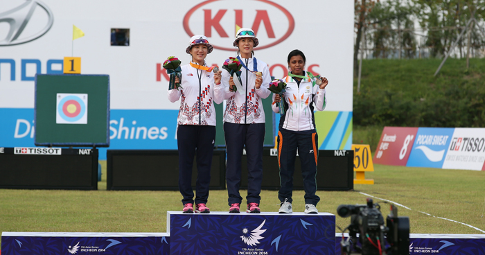 Seok Ji-hyun (left, silver medal), Choi Bo-min (middle, gold medal), and Deb Trisha of India (bronze medal) stand at the podium after the women's individual compound final at the Gyeyang Asiad Archery Field in Incheon on September 27. (photo: Jeon Han) 