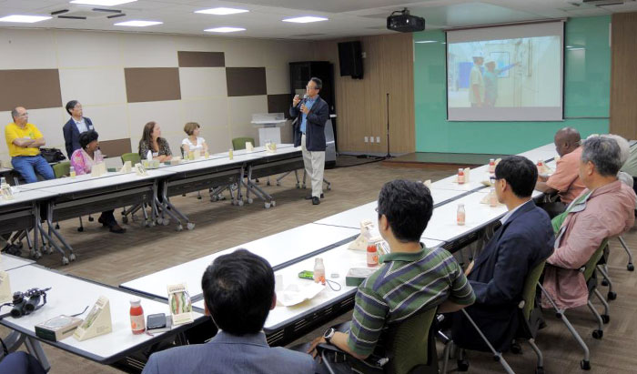 Attendees listen to NIE President Choe Jae Chun’s speech during their visit to Korea's national ecology institute. 
