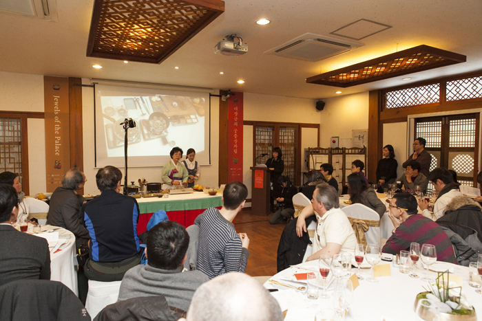 Han Bok-ryeo, president of the Institute of Korean Royal Cuisine, gives a royal Joseon cooking demonstration, as chefs and journalists look on. 