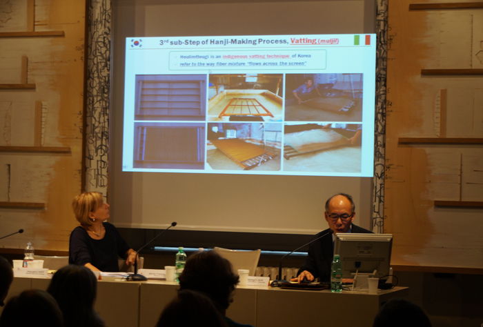 Participants explain the characteristics of Hanji during the conference in Rome, Italy, on October 15. 