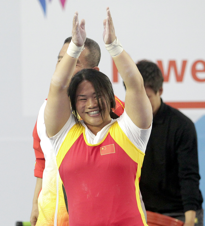 Tan Yujiao from China celebrates her victory after lifting 136 kilograms in the women's 67 kilograms class at the Moonlight Festival Garden Powerlifting Venue on October 21. 