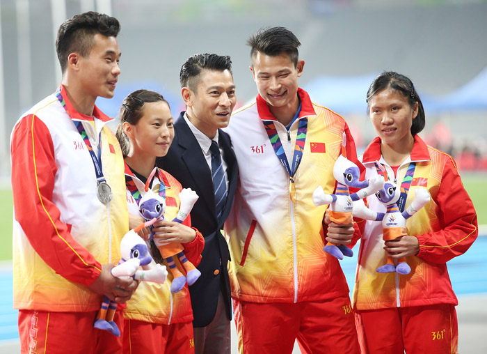 Hong Kong actor Andy Lau (middle), who is a presenter at the Incheon 2014 Asian Para Game, drapes medalists with their medals and poses for a photo with the athletes at the Incheon Asiad Main Stadium on October 20. 