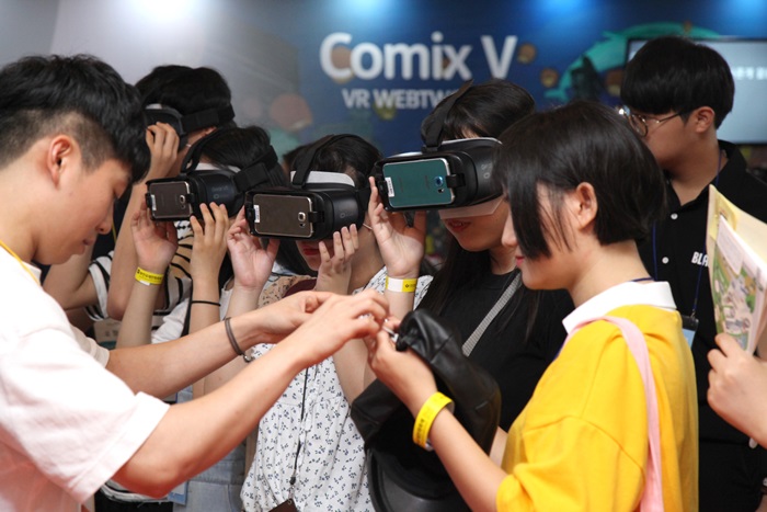 Visitors to the 20th Bucheon International Comics Festival read online comic strips with VR devices, at the Korea Manhwa Museum in Bucheon, Gyeonggi-do Province, on July 22. (Korea Manhwa Contents Agency)