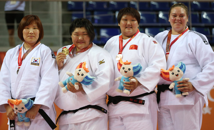 (From left) Kim Min-jeong from Korea (silver), Asahina Sarah from Japan (gold), Kang Jie from China (bronze) and Santa Pakenyte from Lithuania (bronze) stand on the podium during the awards ceremony for the women's +78 kilogram judo competition.