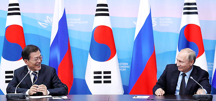 President Moon Jae-in (left) smiles during a joint press conference at the Far Eastern University in Vladivostok, Russia, on Sept. 6, as Russian President Vladimir Putin congratulates President Moon on the Korean national football team making its way into the 2018 FIFA World Cup finals, which will be hosted by Russia.