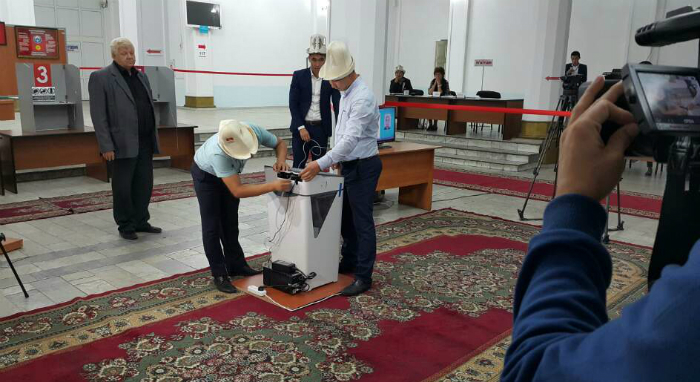 Kyrgyzstani officials collect ballots after the votes close. An automated electoral system was used during parliamentary elections in Kyrgyzstan in October 2015.