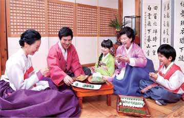A family making songpyeon, half moon-shaped rice cakes, for Chuseok