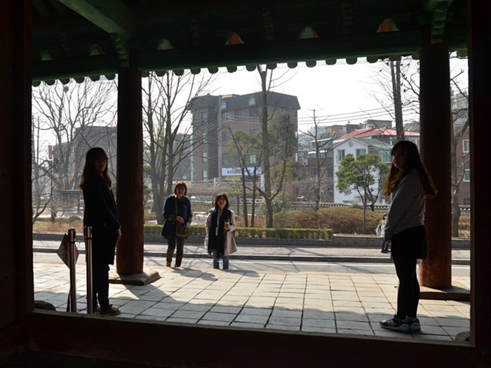 Volunteers stand guard over the central door of Sinsammun, as seen from inside.