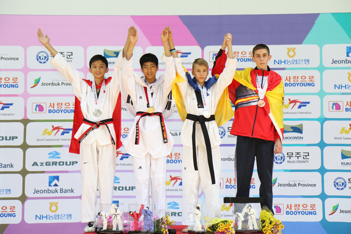 (From left) Vietnam's Dang Quang Pham (silver), Korea's Lee Gi-yeong (gold), Ukraine's Artur Kulida (bronze) and Spain's Jose Bellido Martin (bronze) celebrate after the male -49kg final. 