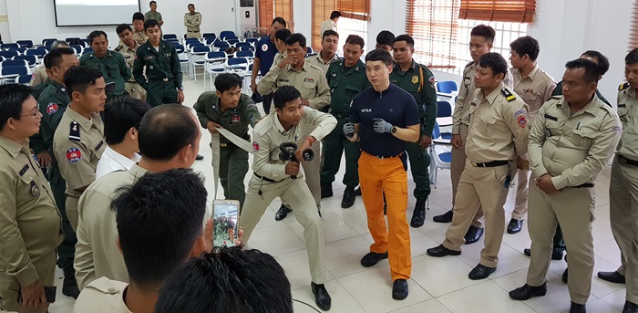 A special delegation from Korea’s National Fire Agency demonstrates for local firefighters how to put out a fire, in Phnom Penh on Dec. 13.