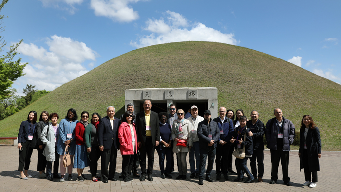 Foreign ambassadors participating in a tour of UNESCO World Heritage Sites in Gyeongju, Gyeongsangbuk-do Province, on April 27 pose for photos in front of Cheonmachong Tomb while visiting the Daereungwon Tomb Complex of Gyeongju Historical Sites.