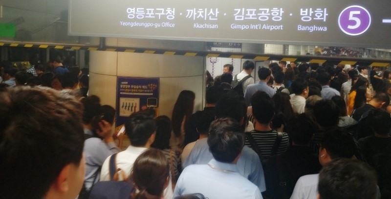The busy business district around Gwanghwamun Station in central Seoul on July 8 around 6 p.m. is packed with workers going home.