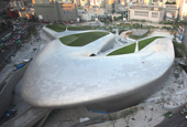 Curved architecture merges with landscape