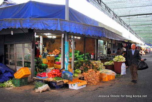 A happy customer passes one of Bangcheon Market’s overflowing stalls