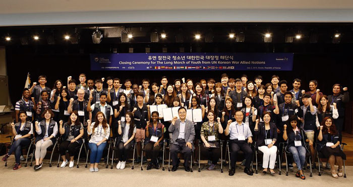 Descendants of Korean War veterans from overseas and Korean students receive scholarships and pose for a group photo during a closing ceremony at the U.N. Peace Memorial Hall in Busan on July 2.
