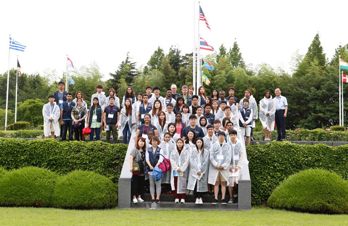 Descendants of Korean War veterans from overseas and Korean students pose for a group photo on July 1 at the U.N. Memorial Cemetery in Korea in Busan.