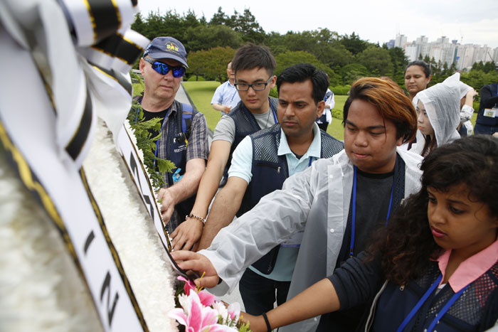 Descendants of Korean War veterans from overseas and Korean students lay a wreath at the U.N. Memorial Cemetery in Korea in Busan on July 2.