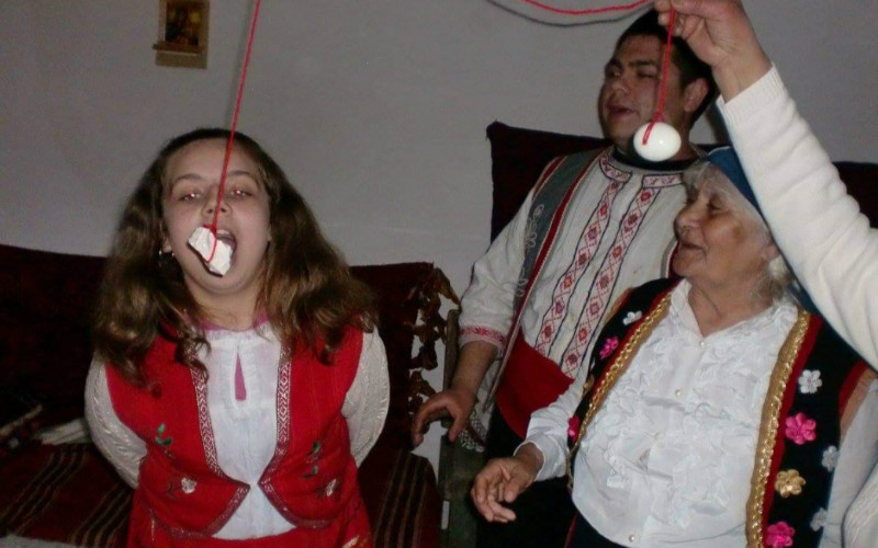 Boiled egg or Bulgarian (halva) dessert is tied by a thread. Children try to catch it with their mouths only, as whoever catches it is said to stay healthy throughout the year.